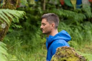 Retreatant meditating outside