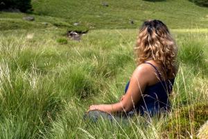 Woman meditating on a hillside